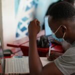 Person using a laptop to build digital skills for employment and small business growth in Ghana