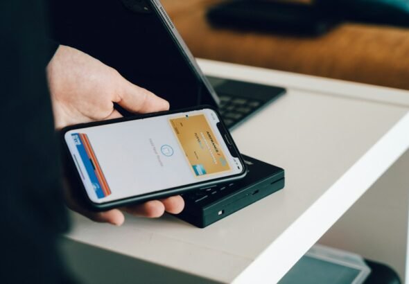 Smartphone and payment card illustrating digital finance