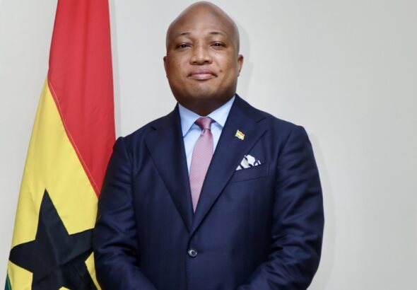 Ghana Foreign Affairs Minister Samuel Okudzeto Ablakwa beside the Ghana flag; official portrait